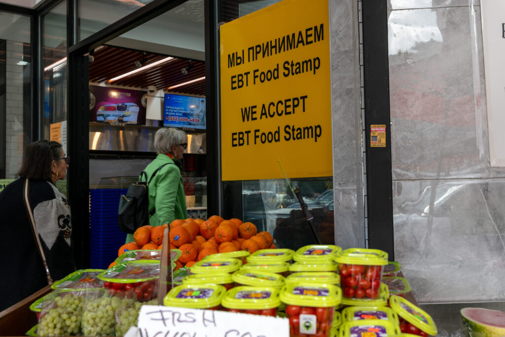 People walk into a New York City grocery store that accepts food stamps. The poverty rate declined last year, but participation in the Supplemental Nutrition Assistance Program (SNAP), commonly known as food stamps, is up in 18 states. (Photo by Spencer Platt/Getty Images)
