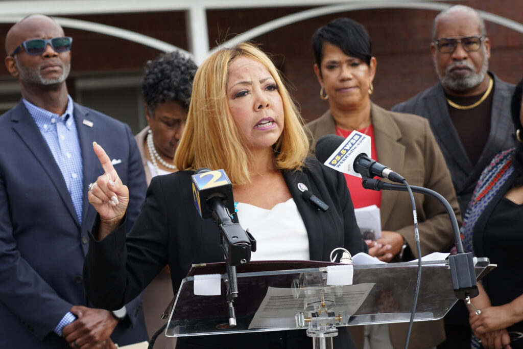 Rep. Lucy McBath speaks with reporters from podium