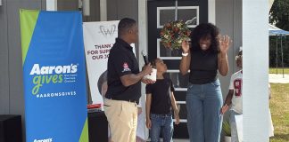 Former Falcon Warrick Dunn helps two families furnish new homes