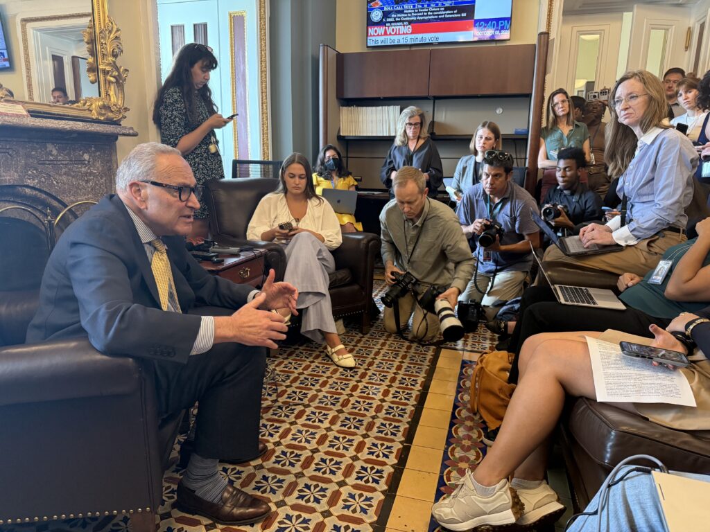 U.S. Senate Minority Leader Chuck Schumer, D-N.Y., speaks with reporters in the U.S Senate press gallery on Wednesday, Oct. 8, 2025. (Photo by Jennifer Shutt/States Newsroom)